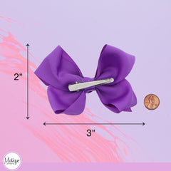 motique bows worn in child's hair for a coordinated outfit accent