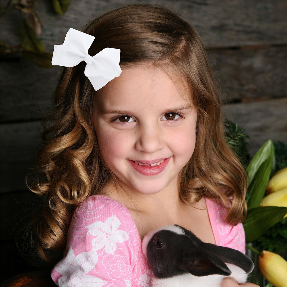 Motique Accessories bow beside ruler for scale to show 3-inch size
