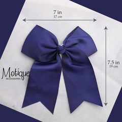 Motique Accessories bow beside ruler showing 7 inch width for scale