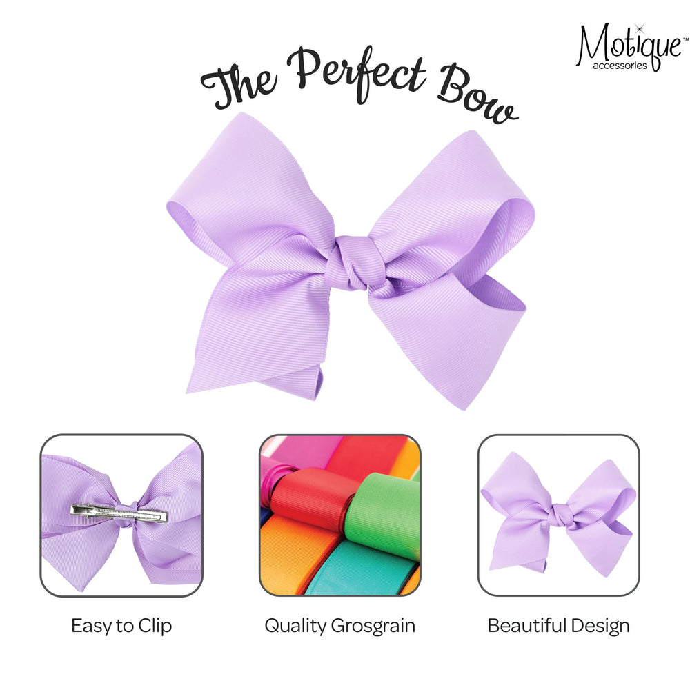 Motique Accessories bow beside ruler showing 5.5 inch size for scale