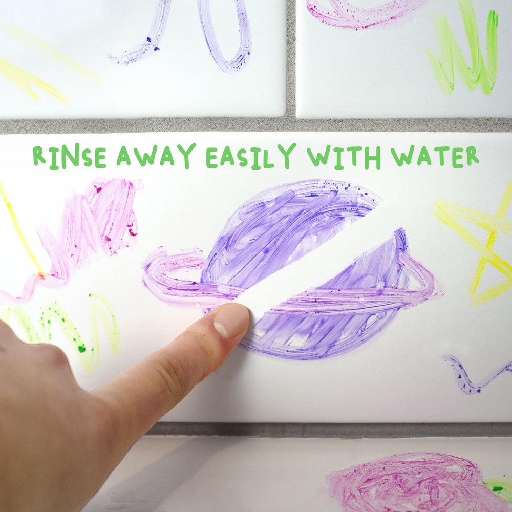 Rinsing paint from skin with water showing Mr. Bubble wash-off ease
