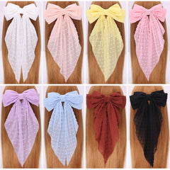 MRJ bow clipped on a gift bag suggesting decorative use and charming presentation