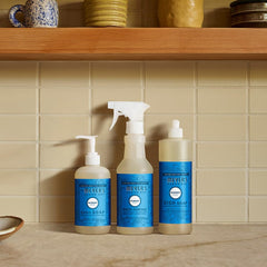 Mrs. MEYER'S size comparison with hand showing 12.5 oz scale and countertop fit