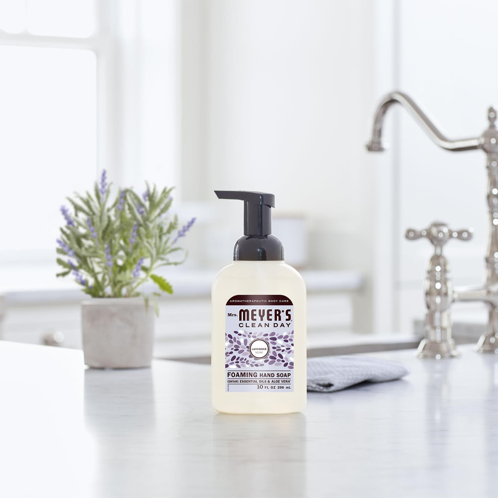 Mrs. MEYER'S bottle held in hand showing 10 oz scale and convenient size benefit