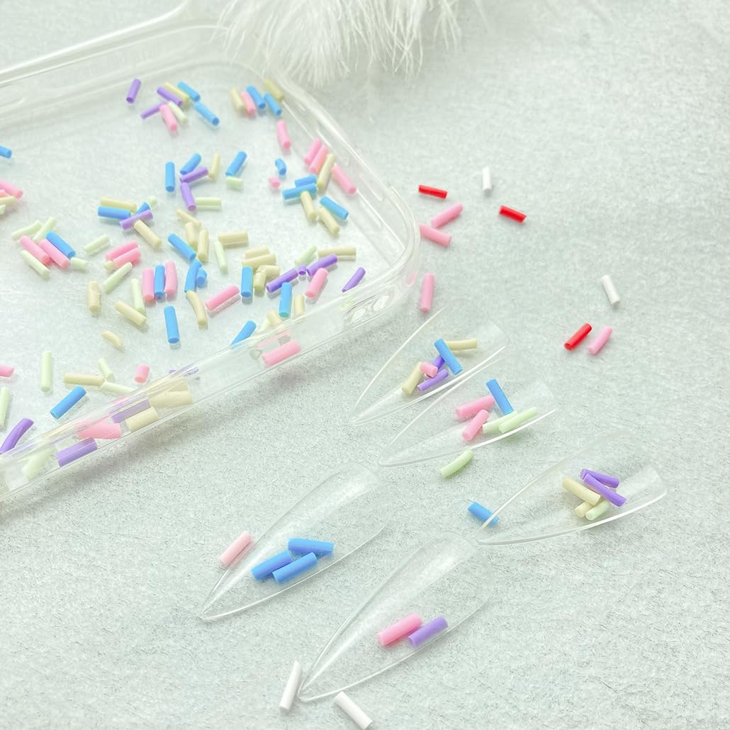 Mulutoo sprinkles next to a teaspoon, demonstrates compact quantity size