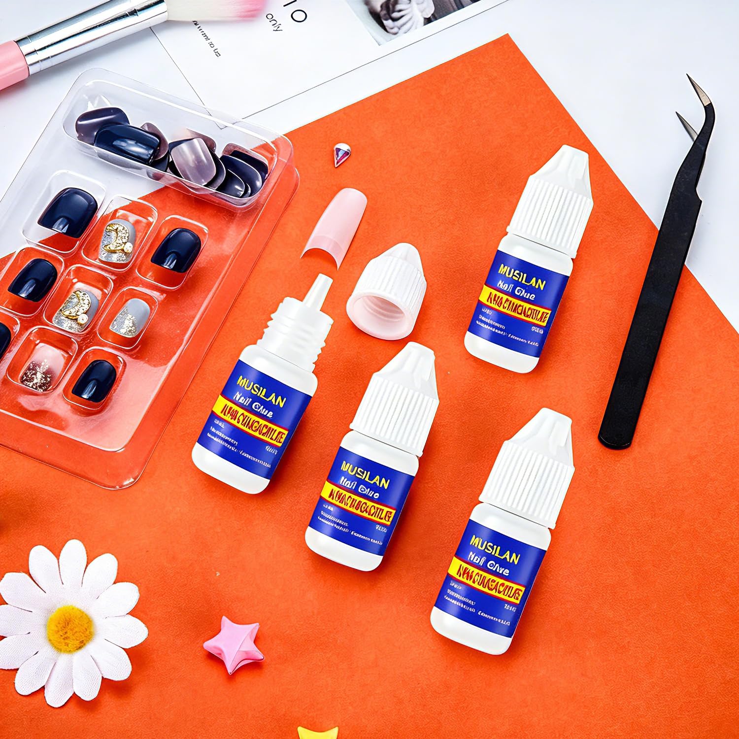 MUSILAN holding rhinestone on nail, adhesive secures small decorations