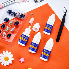 MUSILAN holding rhinestone on nail, adhesive secures small decorations