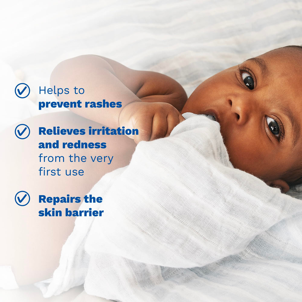 Mustela applying cream to baby diaper area to soothe and protect