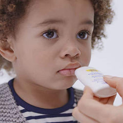 Mustela nourishing stick being applied to baby cheek for gentle soothing
