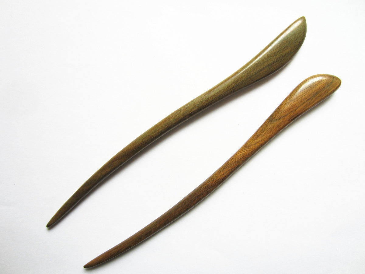 Myhsmooth front view of two carved green sandalwood hair sticks for strong hold