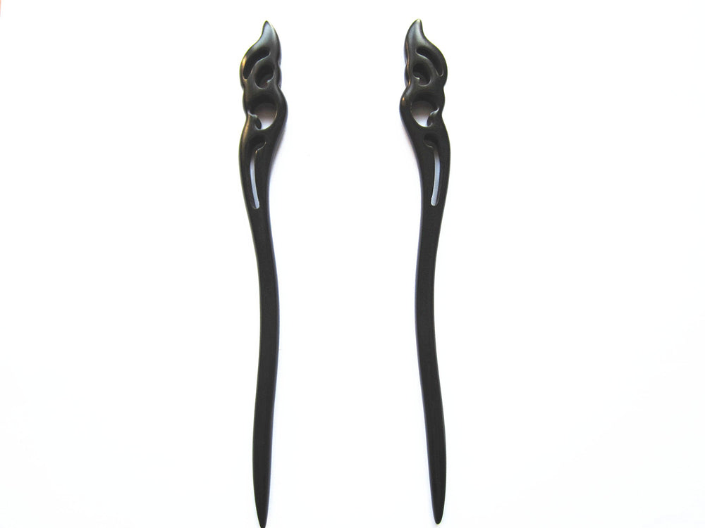 Myhsmooth front view of two ebony sticks showing elegant hold the moon carving and secure styling benefit