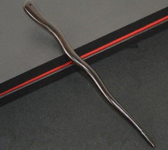 Myhsmooth in use securing a bun for stable, polished updos
