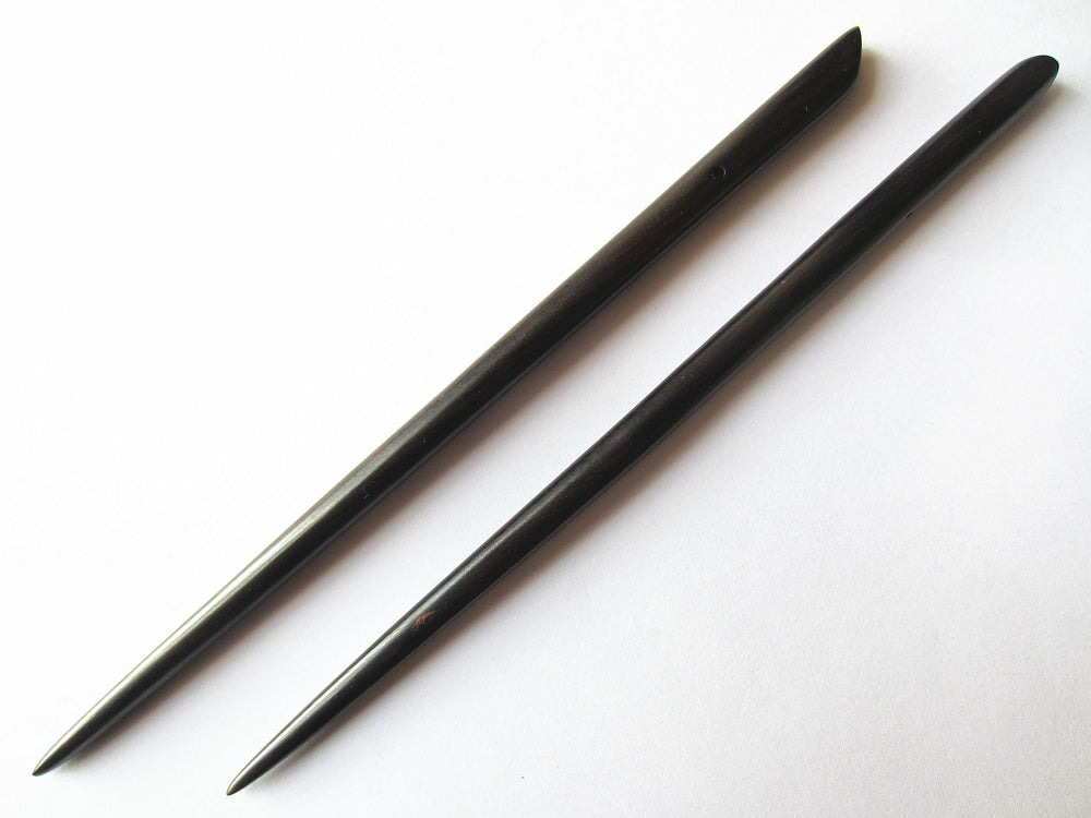 Myhsmooth hair sticks inserted in bun demonstrating secure, polished updo