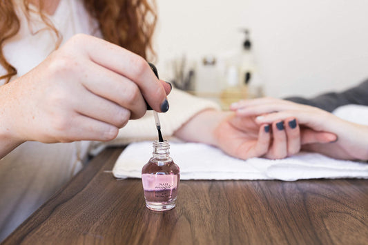 Nail Magic brush applying top coat for smooth, even coverage benefit