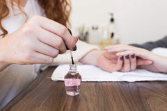 Nail Magic brush applying top coat for smooth, even coverage benefit