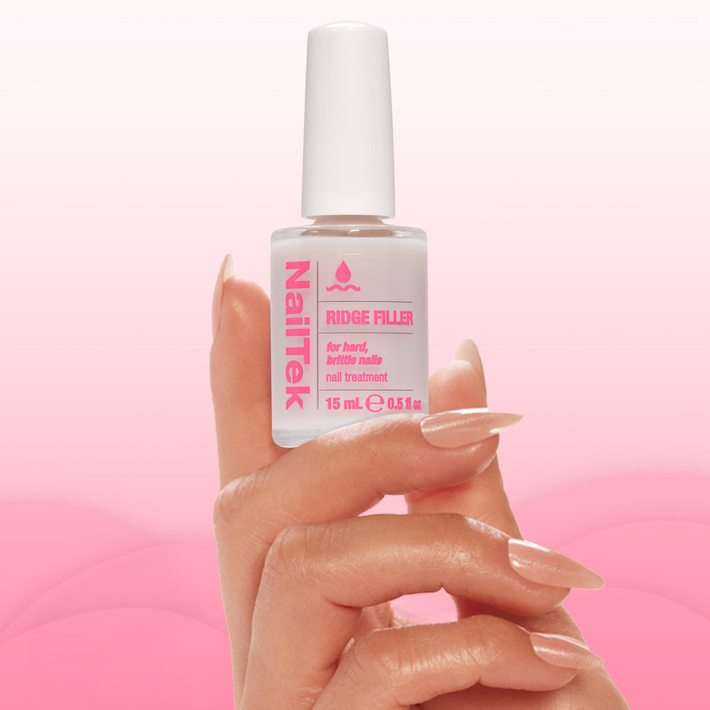 Nail Tek bottle held in hand to show size and easy home-use benefit