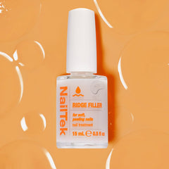 Nail Tek next to a ruler for size scale showing compact 0.5 fl oz convenience