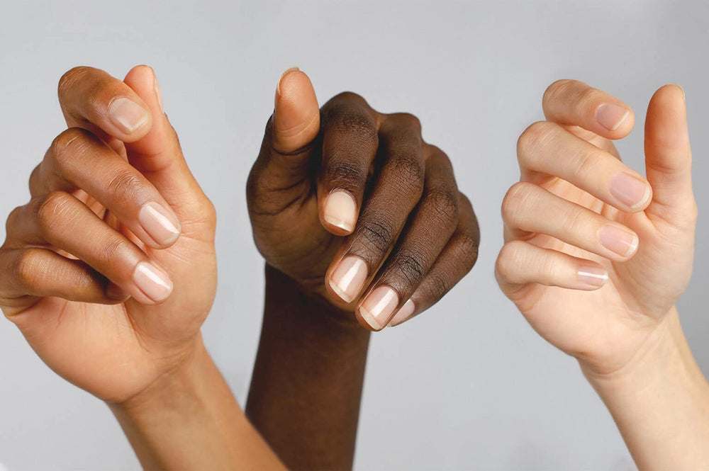 Nailtiques being applied to natural nail, illustrating strengthening benefit during use