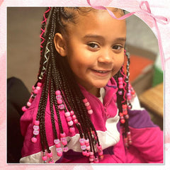 NAISKA beads clipped on child’s braid adding playful colorful detail