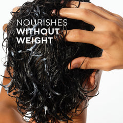 Hand applying Native conditioner demonstrating smooth detangling benefit
