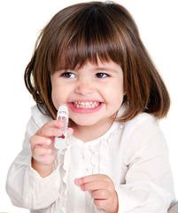 Naturistick in use with a tube beside a purse and laptop for on-the-go lip care