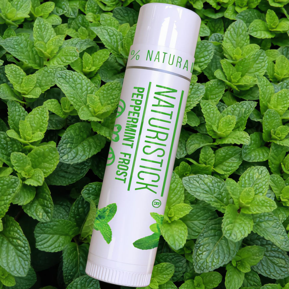 Naturistick open tube applying balm to lips to show non-greasy hydration benefit