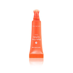 Naturium Phyto-Glow Lip Balm applied on lips in lifestyle setting showing dewy shine benefit