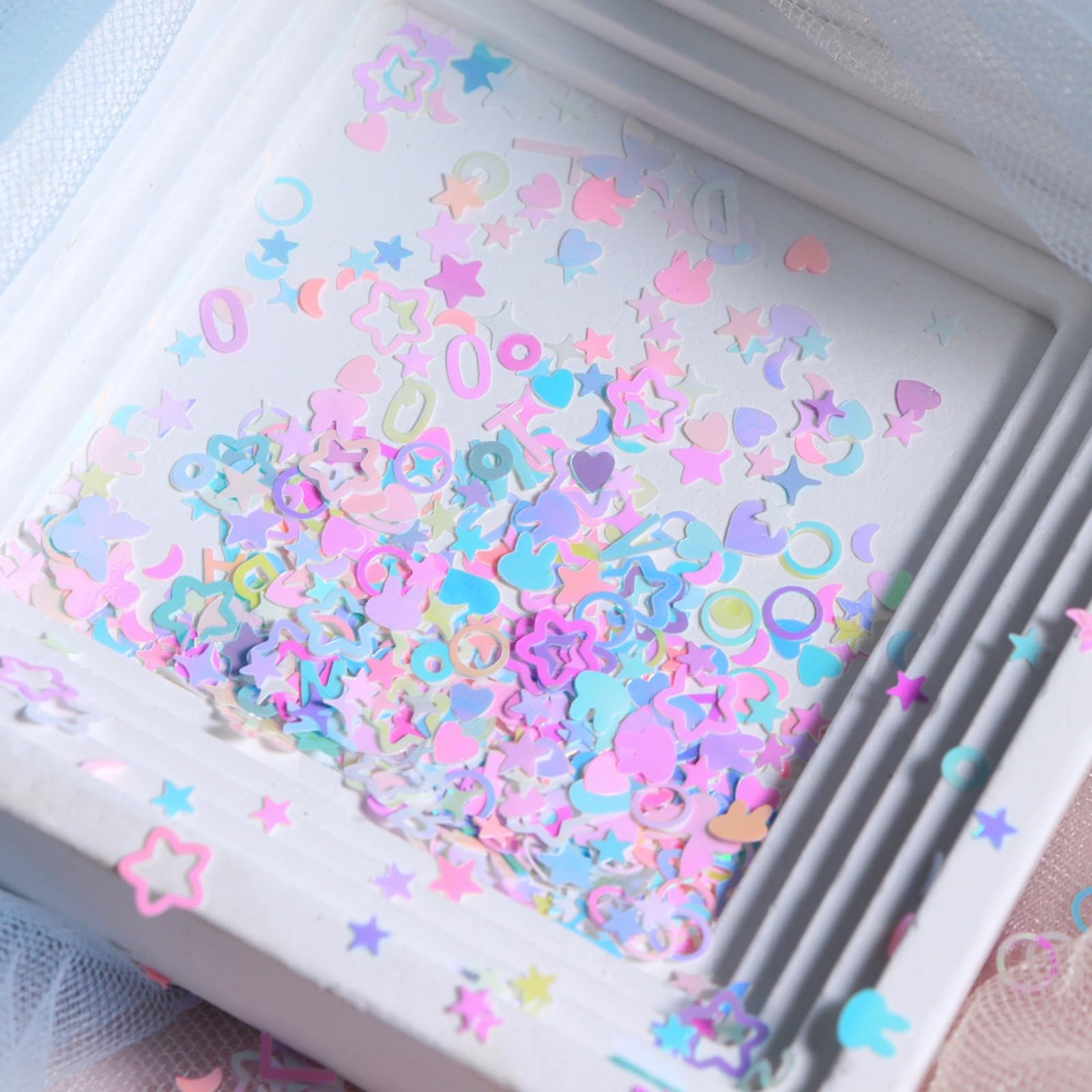 NBNTGH sequins next to a fingertip, size comparison for design planning