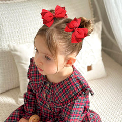 NCMAMA bow clipped in girl's hair illustrating styling and comfort