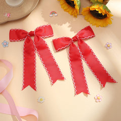 NCMAMA bow held in hand to display 7.3-inch size and easy placement