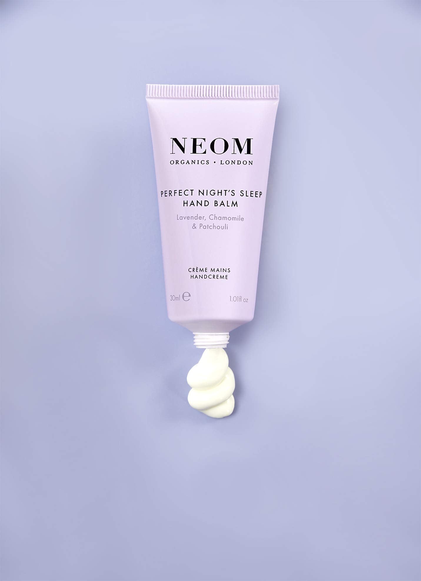 Neom hand balm ingredients label highlighting natural essential oils benefits