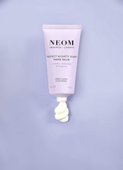 Neom hand balm ingredients label highlighting natural essential oils benefits