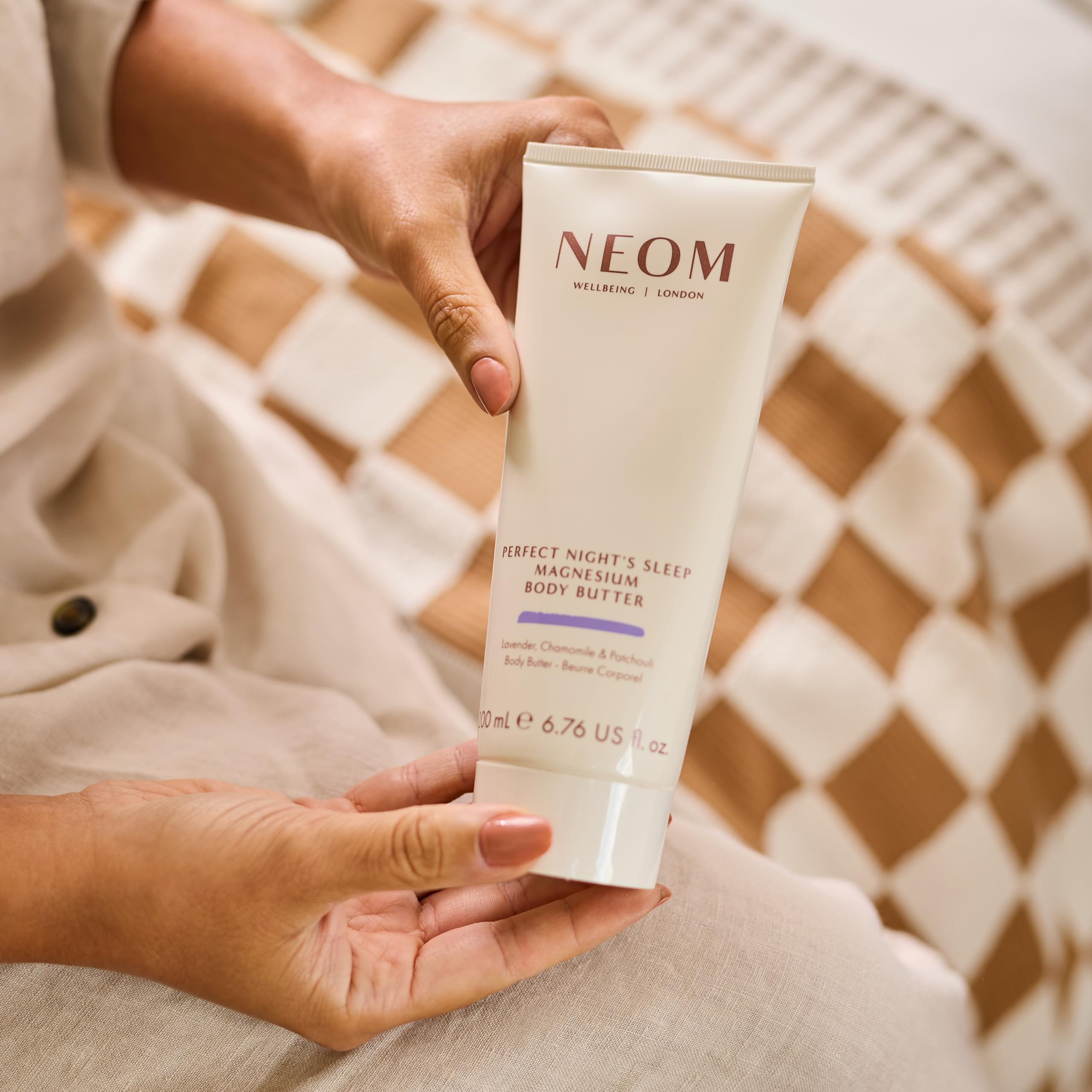 Neom open jar texture close-up showing rich buttery cream and easy absorption