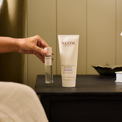 Neom jar with fresh flowers highlighting botanical scent and wellbeing gift