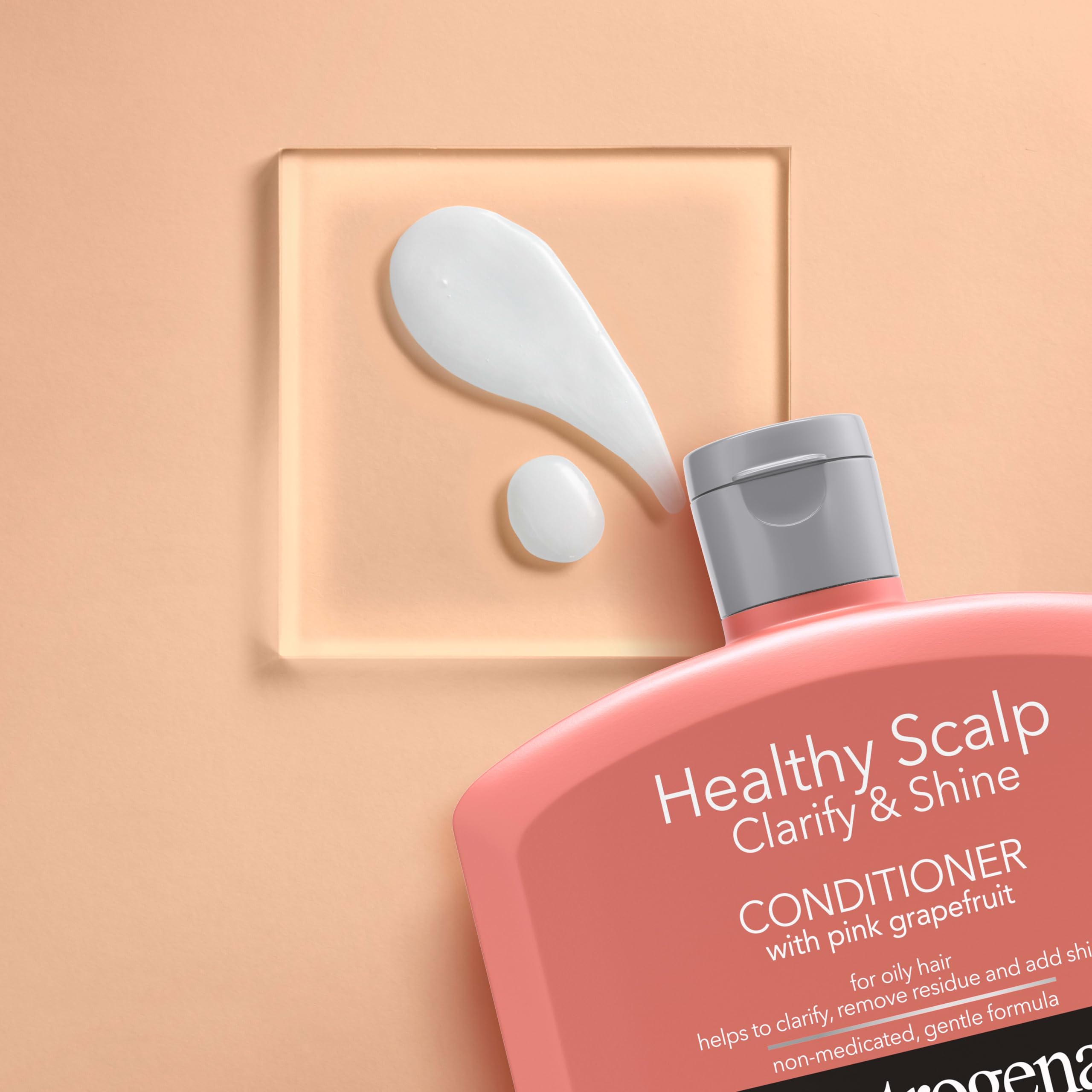 Neutrogena bottle staged with pink grapefruit fruit emphasizing refreshing scent benefit