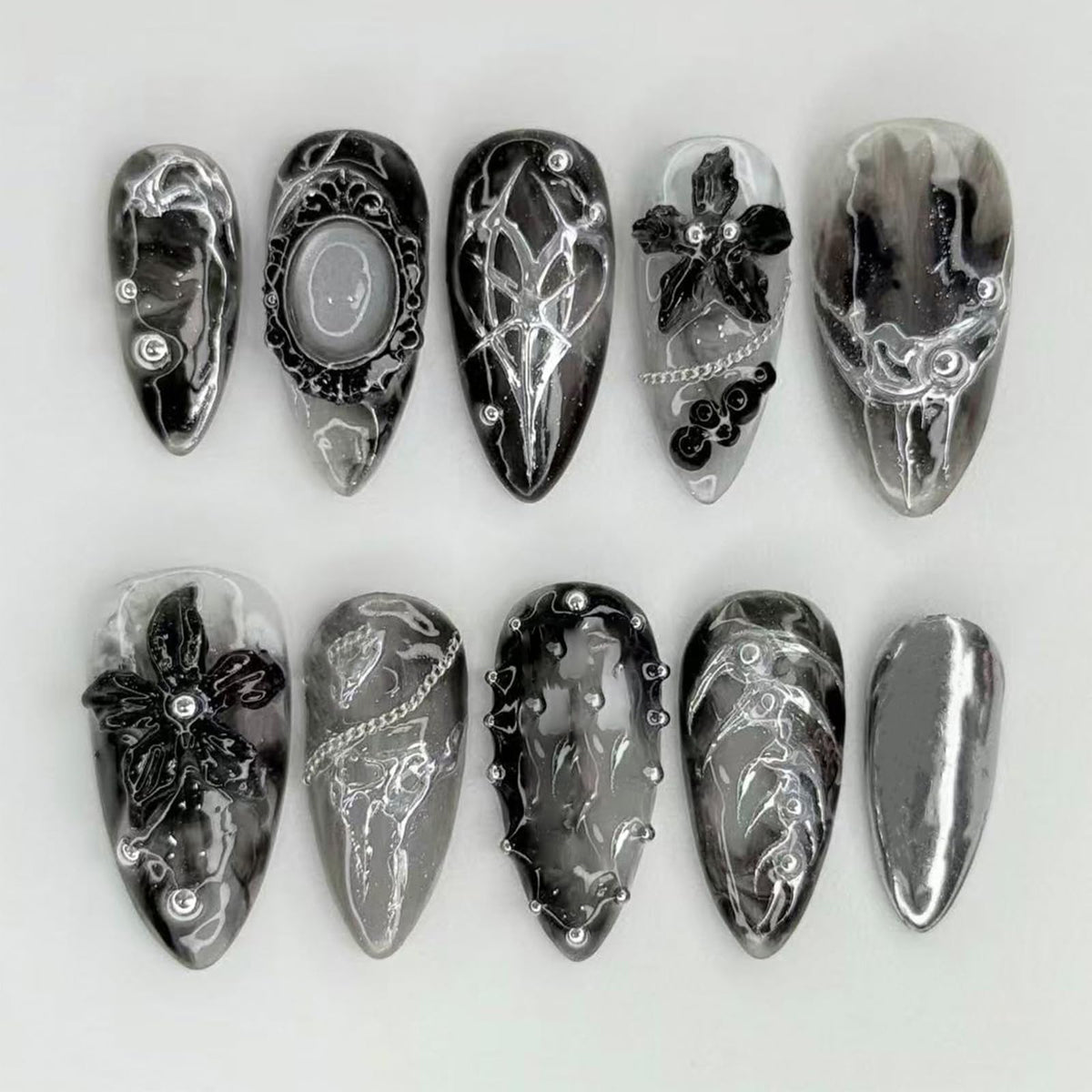NEWSPIED front packaging showing 24-piece gothic press-on nails, ready-to-wear benefit