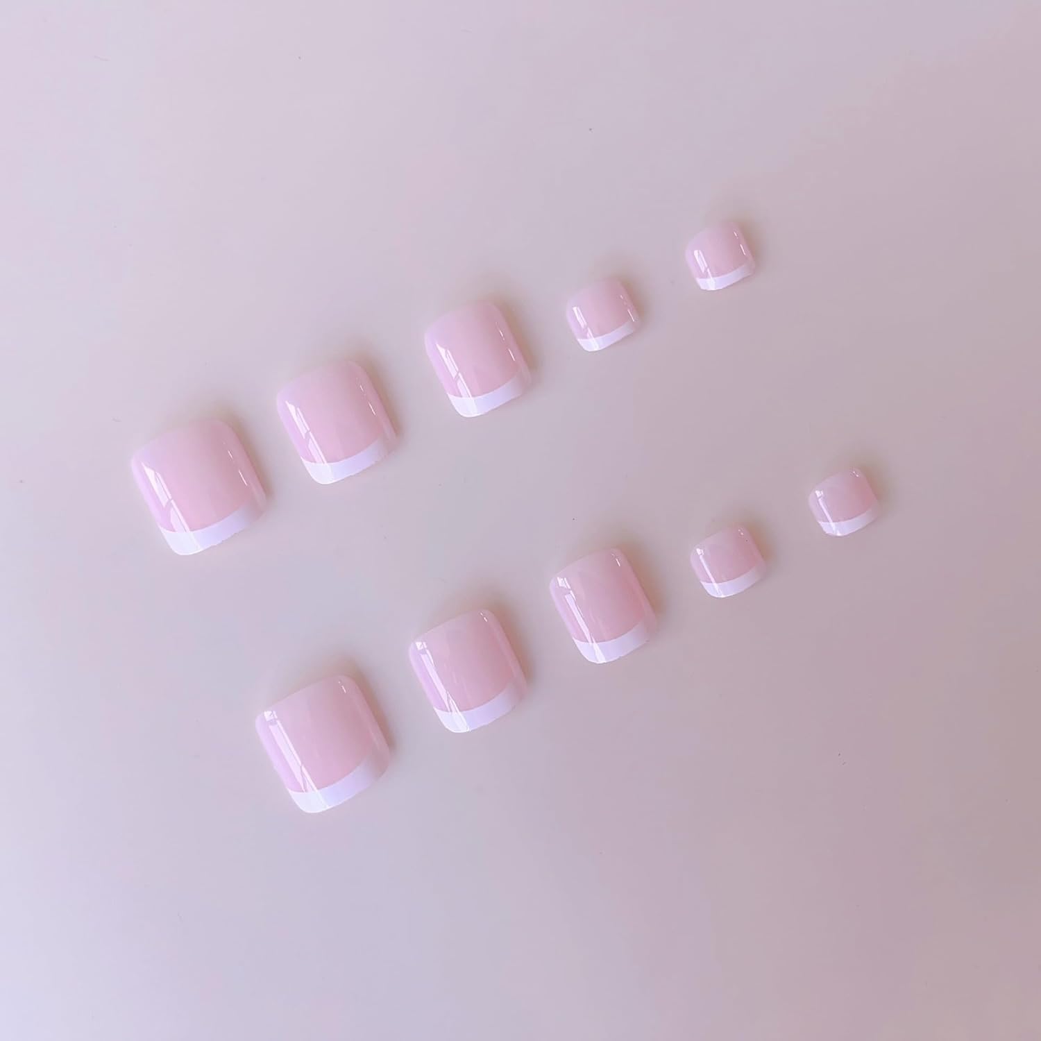 NHIXK applying a press-on nail on a finger, demonstrating simple 15-second at-home application
