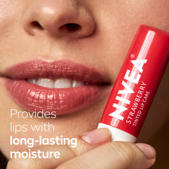 NIVEA lip balm in hand showing compact travel-friendly size benefit