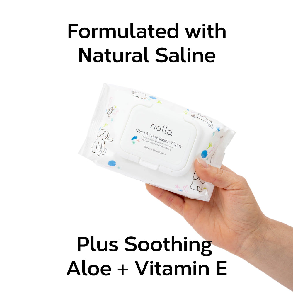 Hand using Nolla wipe on baby cheek showing quick, soothing cleanup