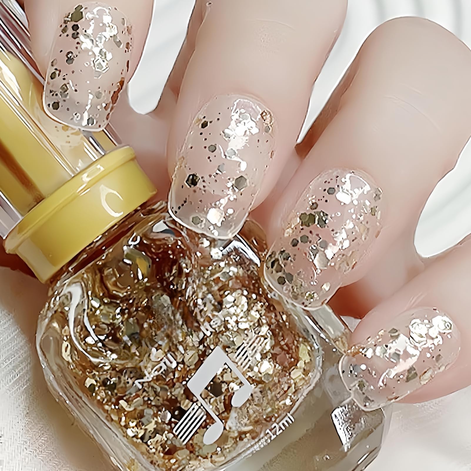 NovaCharm front bottle with gold glitter showing clear base and shine benefit