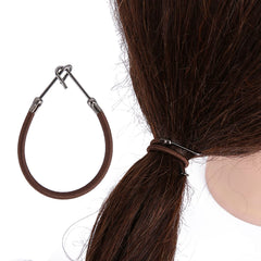 NSBELL hair ties beside a ruler to show approximate nine-inch stretch