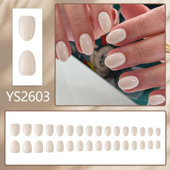 Nxtpz model wearing short almond nails, demonstrates natural-looking, polished manicure