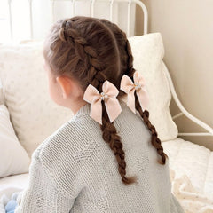 OAOLEER bows worn in pigtails on child demonstrating neat styling
