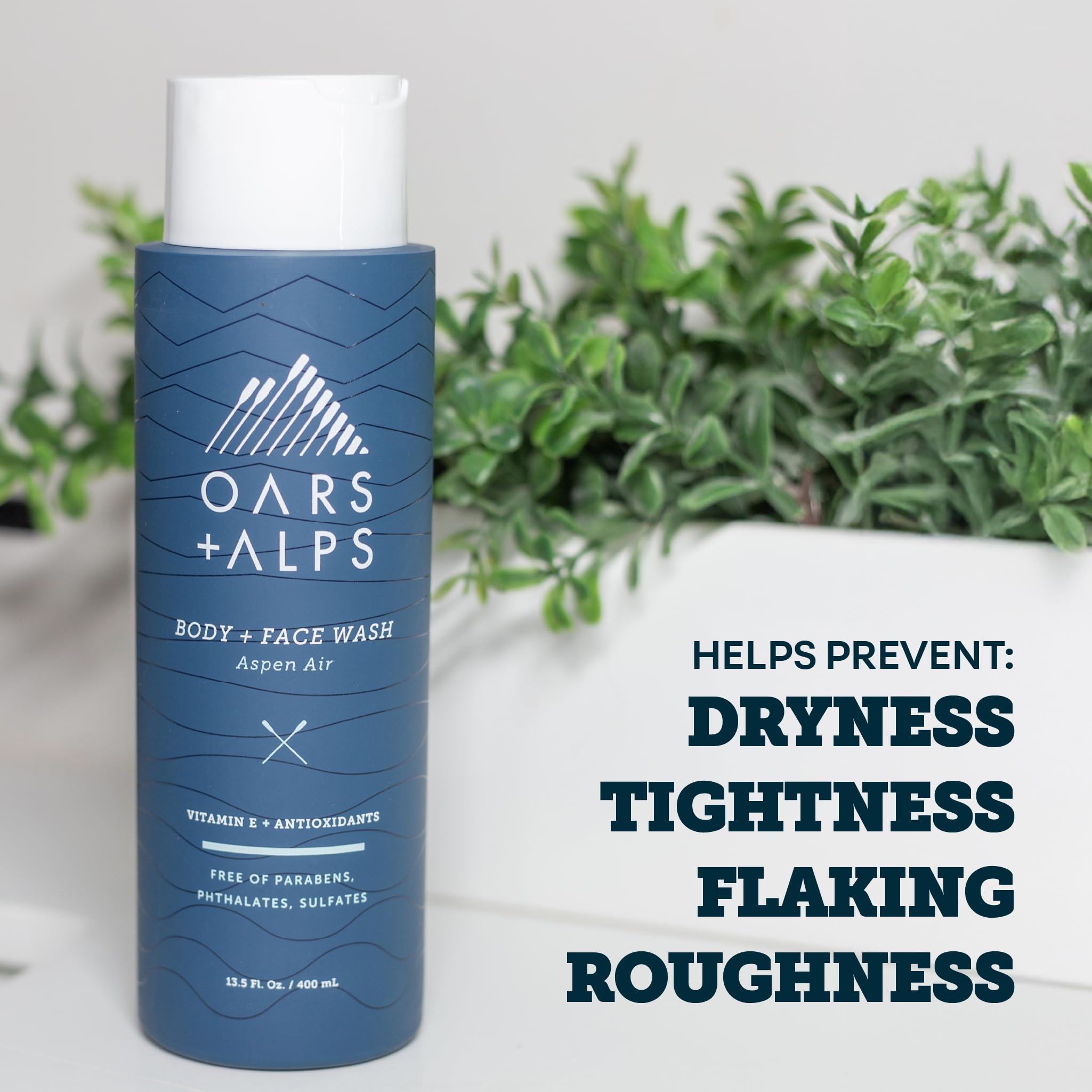Oars + Alps bottle beside hand for size comparison and travel-friendly benefit