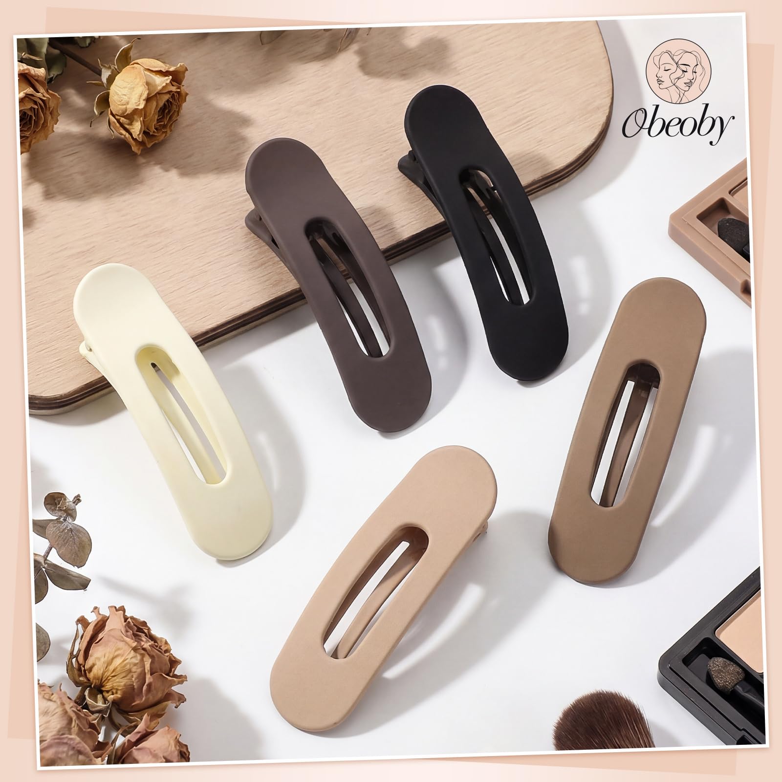 obeoby clip held in hand to show 3.1 inch size and scale