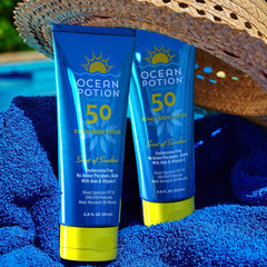 Ocean Potion bottle on beach towel conveying outdoor-ready, travel convenience