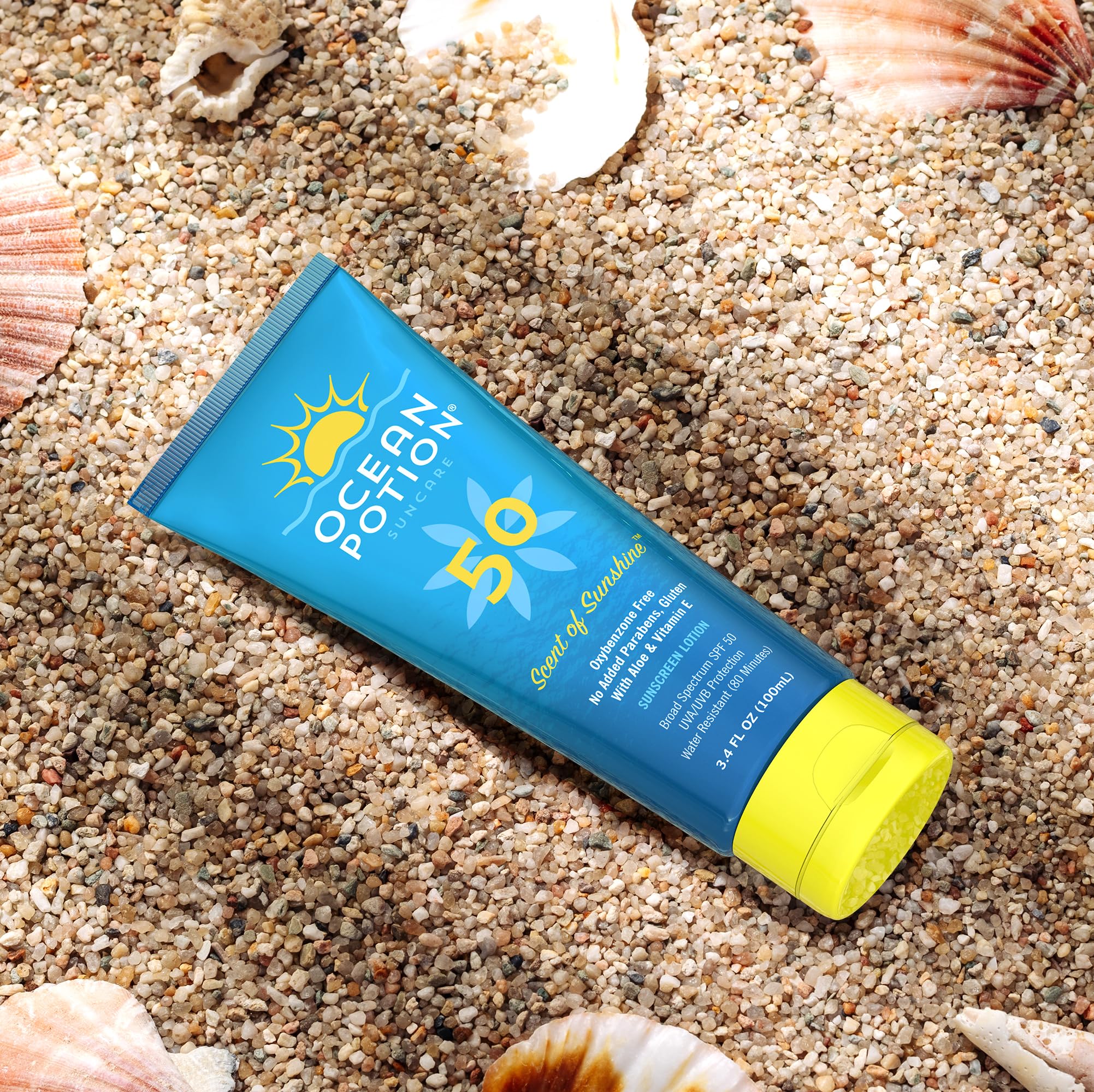 Ocean Potion bottle beside sunglasses showing compact travel-friendly size