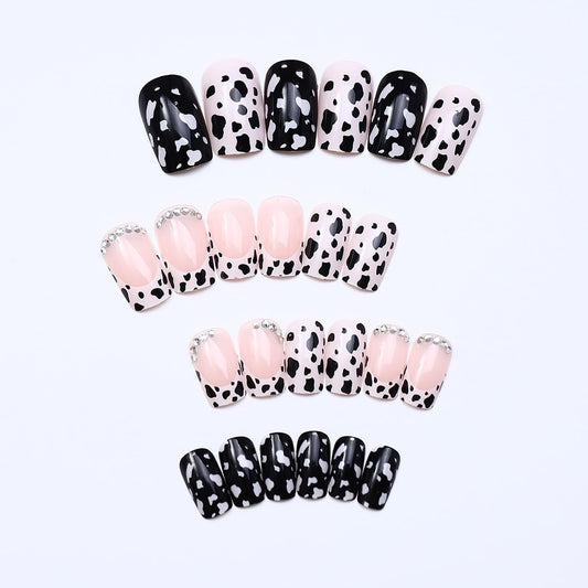 OCOUYVD close-up of cow-print accent nail highlighting bold pattern