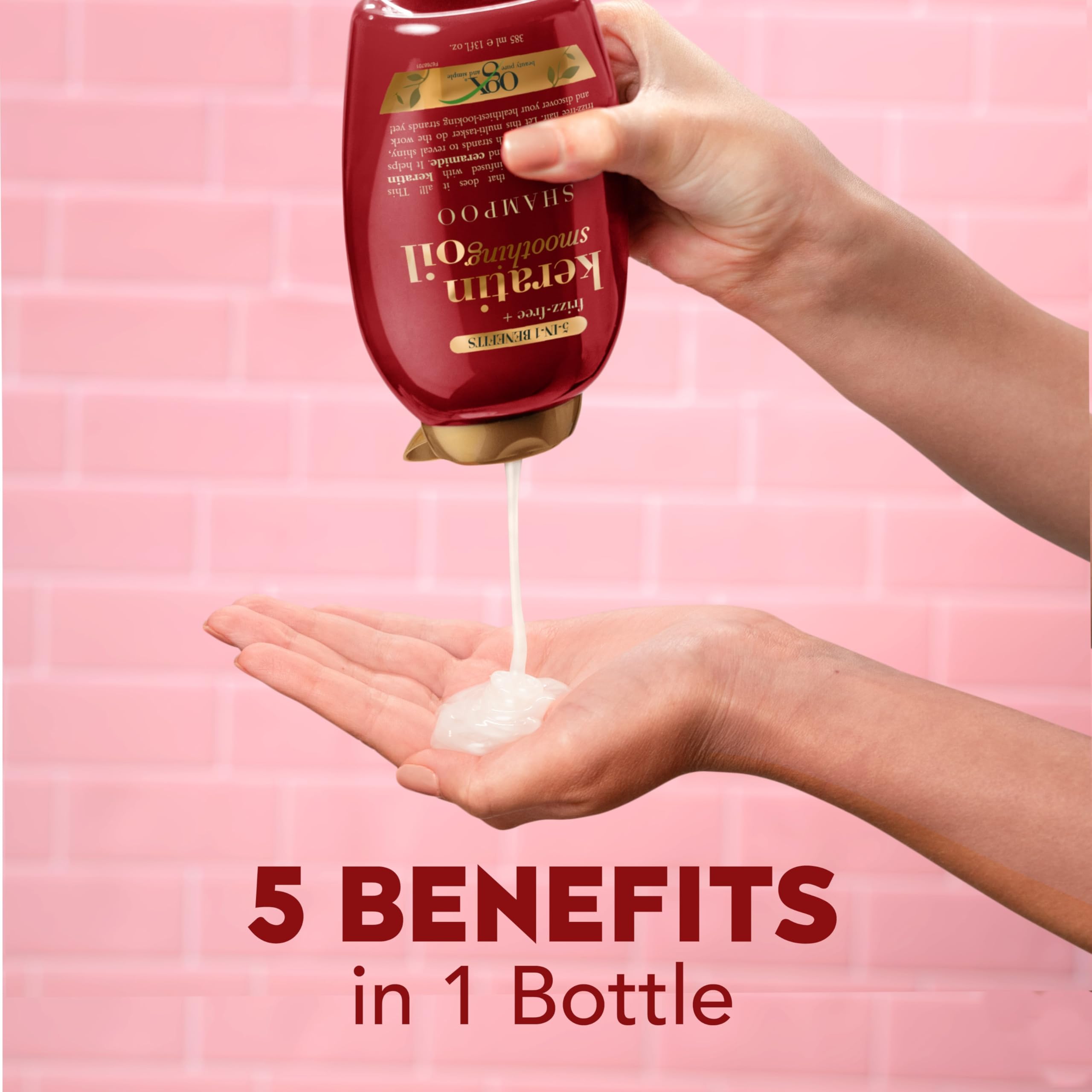 OGX bottle held in hand to show true 13 fl oz size and travel convenience