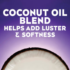 OGX applying conditioner to mid-lengths and ends to show frizz control benefit